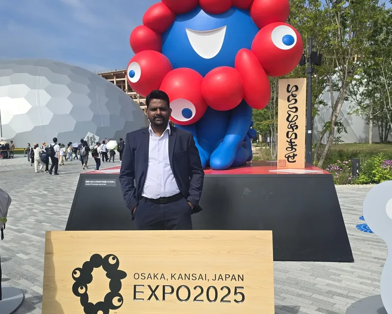 Standing in front of the Expo mascot and the Expo 2025 Osaka, Kansai, Japan sign