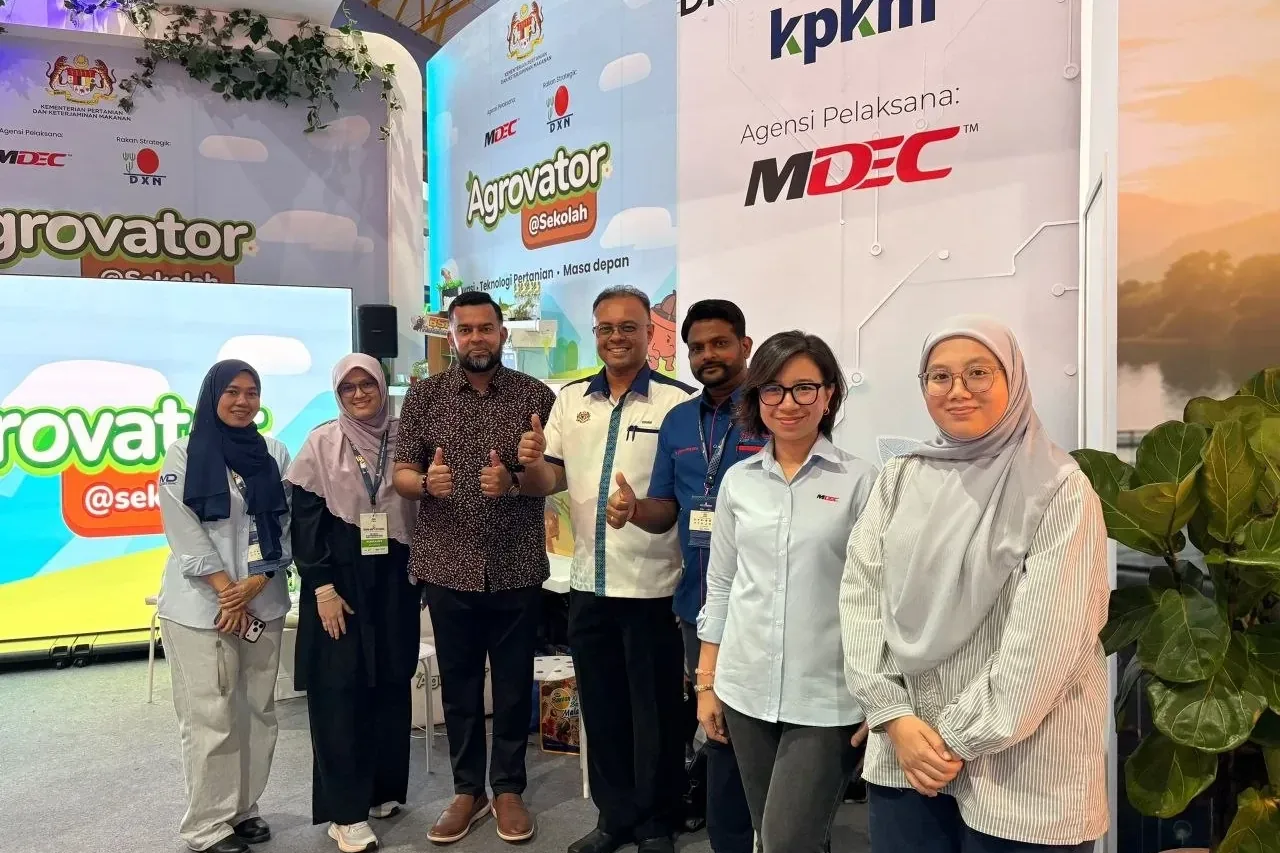 Seven people in front of the Digital AgTech KPKM wall, which names MDEC as its implementing agency