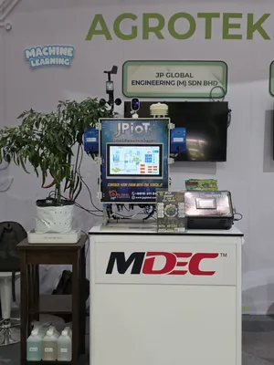 The JPIoT stand on the MDEC counter: the JPIoT Smart Agriculture System with its weather sensors, a chilli plant and the Smart 7-in-1 Soil Tester