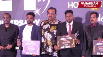 The honourees on stage with their certificates at the 21st anniversary celebration